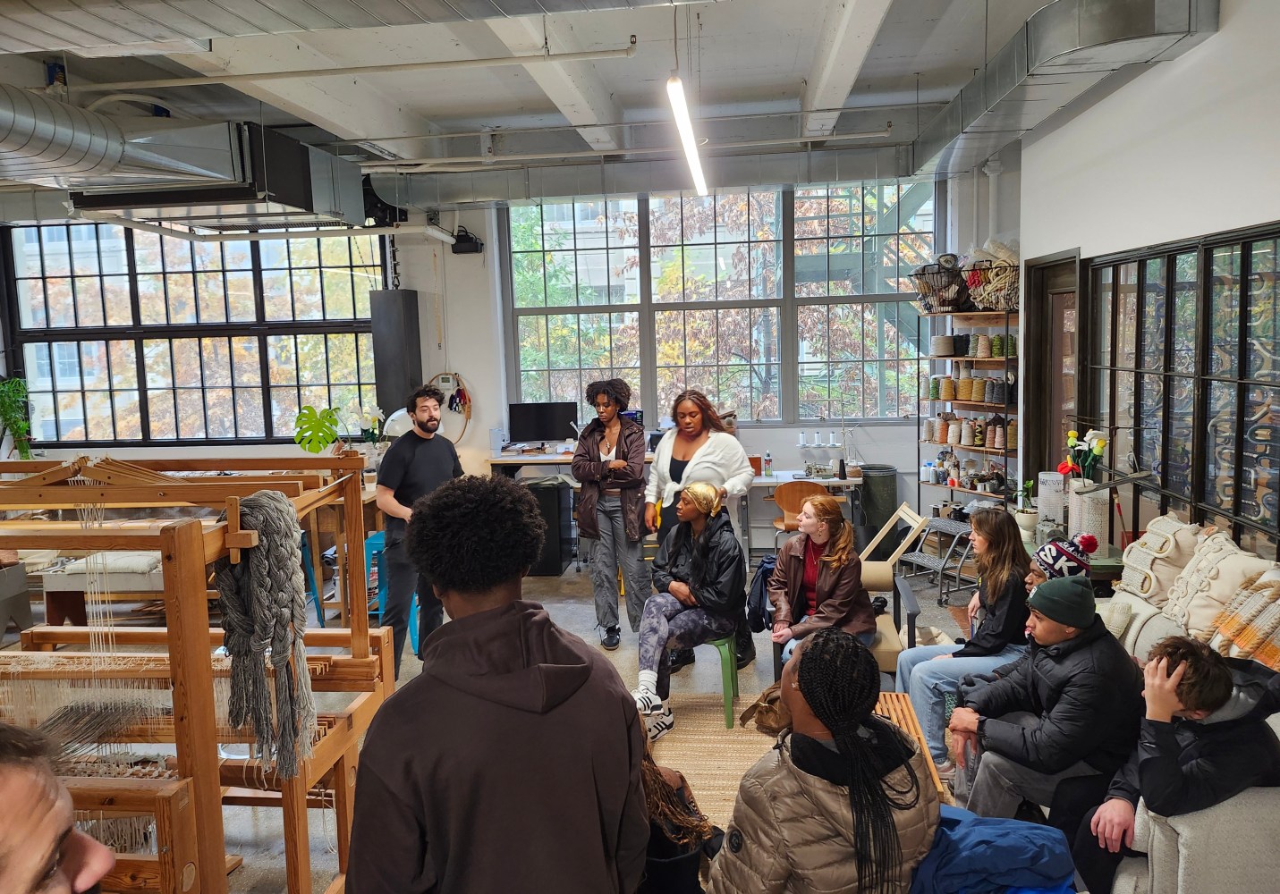 a group of students in a room learning about textiles